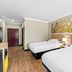 Days Inn by Wyndham Rockdale Texas guest room with two beds and forest wall art