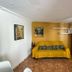 Chambres D'hotes Du Domaine Des Doudous room in Saint-Pierre with yellow sofa, fridge and blue curtains
