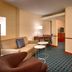 Fairfield Inn & Suites by Marriott Boise Nampa guest room with seating area, TV, and desk in Nampa