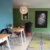 Hotel Rossi in Sartène dining area with patterned floor, colorful chairs, and green walls