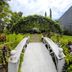 Sunny Point Hotel in Davao City garden with white arched footbridge and lush tropical landscaping