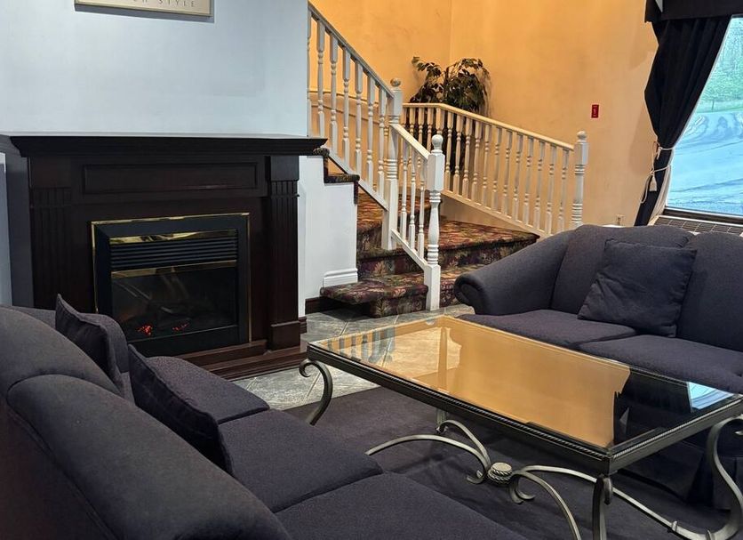 Bridgewater Hotel in Bridgewater lobby with fireplace, sofa seating, glass coffee table and staircase