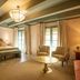 Hospes Las Casas del Rey de Baeza in Seville, guest room with king bed, seating area and French doors
