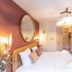 Bhoma Bourges - Hôtel guest room with bed, wall mirror, desk, TV, and lounge chair in Bourges