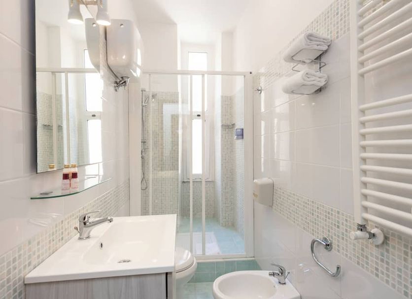Parker Rome bathroom with walk-in shower, wall-mounted sink and heated towel rail