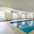 Cobblestone Hotel & Suites - Mccook indoor pool in McCook with lounge chairs and windows