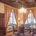 Hotel Vier Jahreszeiten in Volkach: elegant lounge with chandelier, striped drapes, and antique furniture