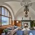 Grace La Margna St Moritz lounge with vaulted ceilings, fireplace, mountain-view window and sofas