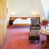 Waldhotel Bärenstein in Horn-Bad Meinberg bedroom with seating area and large window view