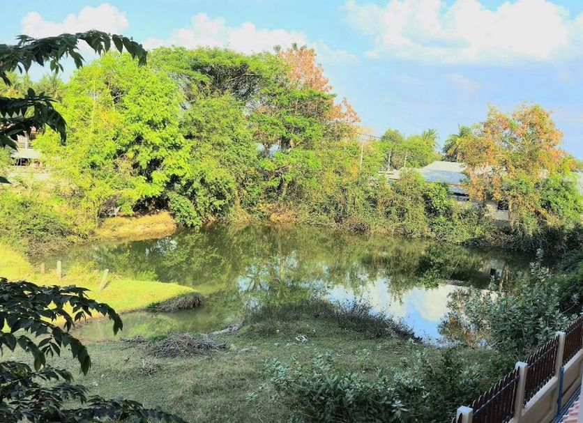 Bumnsaya Place in Nang Rong with a small pond and lush garden view