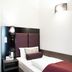Fair Hotel Europaallee Frankfurt am Main guest room with single bed, wall light and bedside table