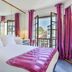 Logis Hotel Bergeret Sport room in Hendaye with bed, mirrored wall, and balcony doors to city view