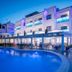 Apartamentos Sal Rossa in Sant Josep de sa Talaia with a lit pool and modern terrace at dusk