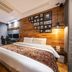 Suwon Ingyedong The Blixx guest room with king bed, seating area, and wood accent wall in Suwon