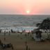 Calangute Residency in Calangute with sunset over the beach and people on the shoreline