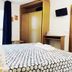La Caleta de Tamariu room with double bed, wardrobe, desk and wall-mounted TV in Tamariu
