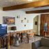 Hostal Los Volcanes Guatemala City lounge with TV, seating area and water dispenser