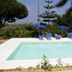 Pool area at B&B Il Cavaliere in Santa Domenica with blue loungers, umbrellas and greenery