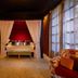 Palma Riad in Palma de Mallorca with a canopy bed, rich drapes, and patterned lounge seating