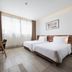 Triple E Hotel Fine Art Museum in Ho Chi Minh City guest room with two twin beds, desk, and large window