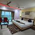 Hotel Sagar Kanya Inn, Puri room with sea view, king bed, seating area and balcony doors
