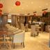 Orchardz Hotel Industri Jakarta lounge with dining tables, beige seating, and red lantern decor