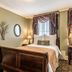 Hotel Bothwell Sedalia Central District, an Ascend Collection Hotel guest room with a bed and desk in Sedalia