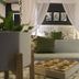 Club Cocomo in Hartbeespoort guest room with canopy bed, green accents, sofa, and patterned tile floor