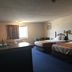 Denison Inn & Suites in Denison guest room with two double beds and a window