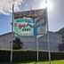 Hotel Plaza Palenque exterior with roadside sign and a banner showing a pool