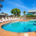 Nrma Ballarat Holiday Park in Ballarat with a large outdoor pool, sun loungers and umbrellas