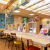 Comfort Hotel Hakata in Fukuoka library cafe with long communal tables and hanging plants