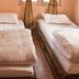 Hostel Himalaya Kathmandu room with two single beds and curtained windows