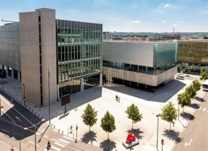 Hotel Les Portes D'Or in Nancy, modern hotel exterior with plaza, trees, and adjacent glass building
