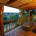 Riverside Guest Lodge in Oudtshoorn, wooden deck with seating and sweeping river valley views