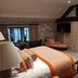 Fence Gate Lodge, Burnley guest room with bed, seating area, wall-mounted TV and open bathroom door