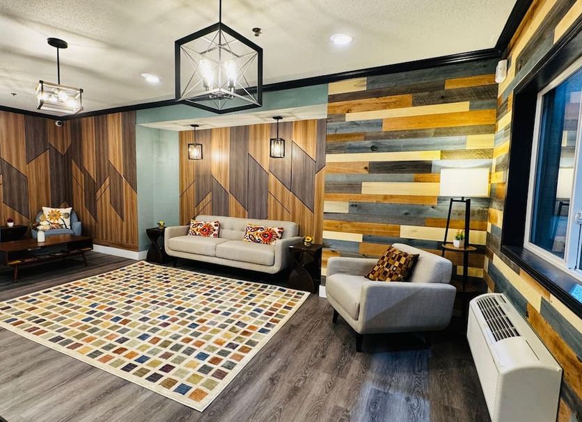 Lobby lounge at Blaine Town Inn & Suites in Blaine with patterned rug, sofa, chairs and modern lighting