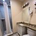 Beachside Resort Motel bathroom in Treasure Island with shower, vanity, and toilet