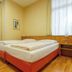 Traveller Hotel in Lübeck guest room with double bed, wooden floors, desk and large windows