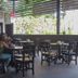 Airport X Managua restaurant seating area with open-air garden views in Managua
