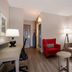 Country Inn & Suites by Radisson Harrisburg Northeast guest suite with sofa, red chair and desk