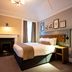 The Hawes Inn by Innkeeper's Collection in South Queensferry, bedroom with fireplace and tufted headboard