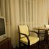 La Petite Apartments & Rooms, Gdansk: seating area with two chairs, round table, lamp and TV