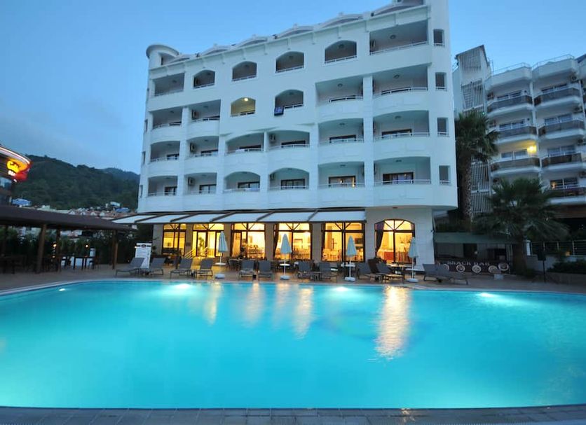 My Dream Hotel in Marmaris with a large outdoor pool and beachfront-style hotel facade at dusk