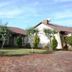 Oak Rest Guesthouse in Kimberley with a lawn, brick driveway, trees, and guesthouse exterior