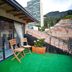 Arche Noah Boutique Hostel Bogotá balcony with chairs, potted plant and mountain city view