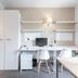 Residencia Universitaria Campus del Mar in Barcelona study room with desks, chairs, cabinets and mini fridge