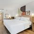 Spark by Hilton Harrisonburg University Area room with king bed, wall art, and wood flooring in Harrisonburg