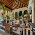 Bahia Del Duque in Adeje: covered terrace with arched columns, seating, and pool view
