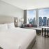 Courtyard by Marriott Seoul Myeongdong guest room with city skyline views and seating area